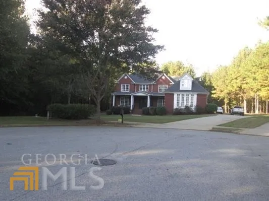 a view of a house with pool and a yard