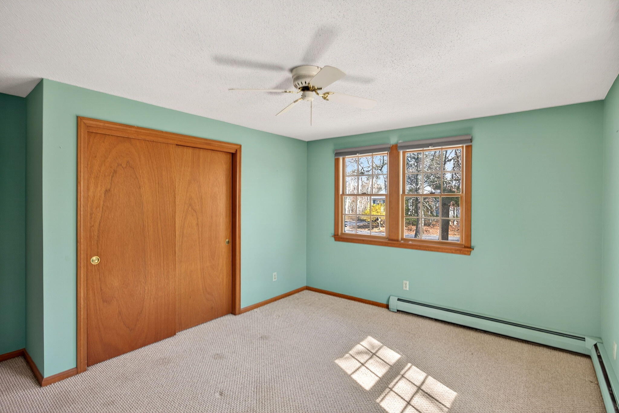 12 Inkberry Lane Harwich, MA 02645 - Photo 18 of 41 an empty room with windows and ceiling fan