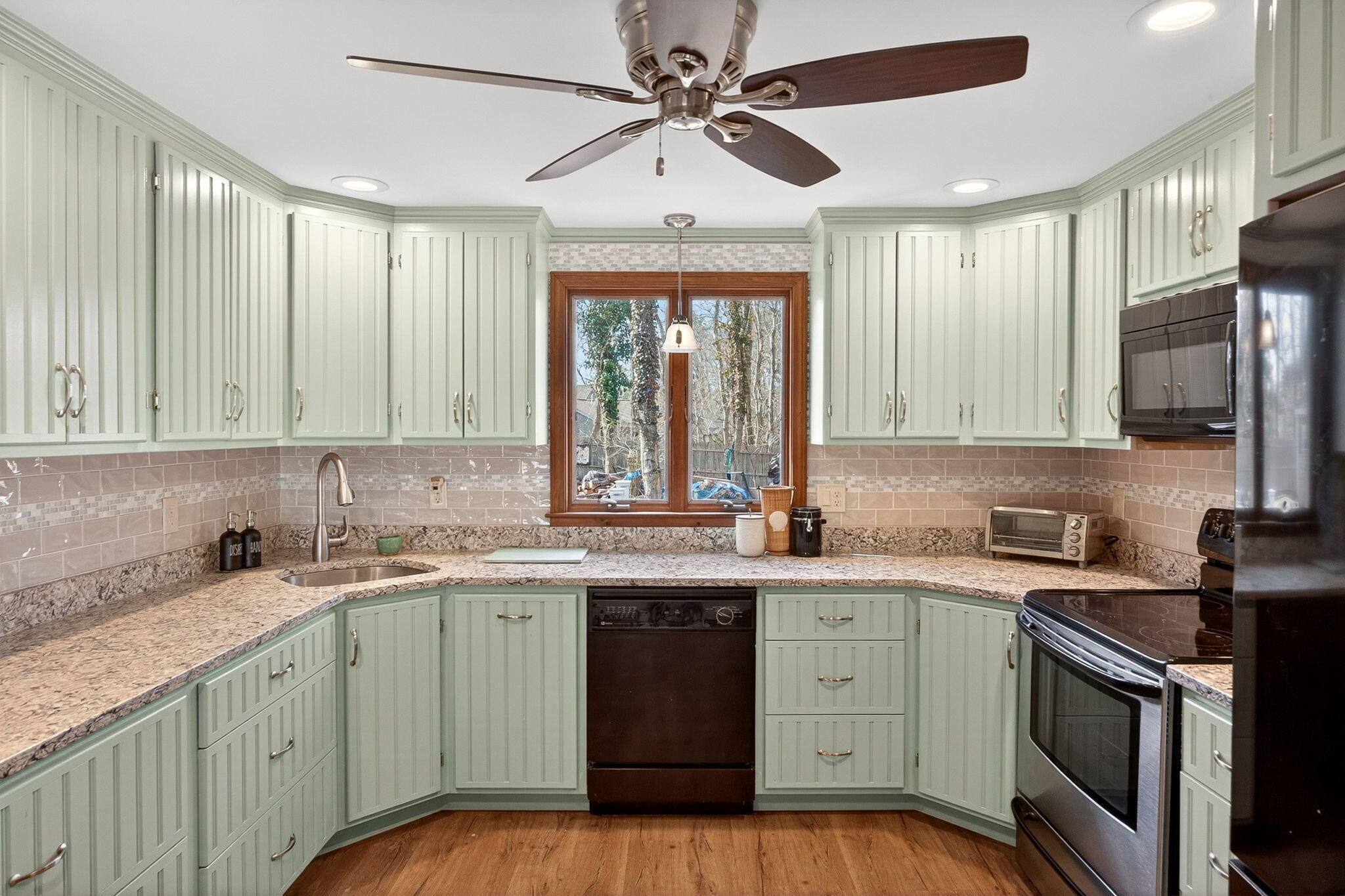 12 Inkberry Lane Harwich, MA 02645 - Photo 3 of 41 a kitchen with a sink stove and cabinets