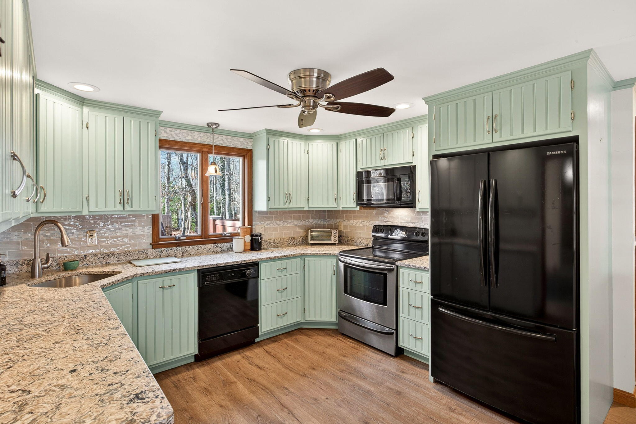12 Inkberry Lane Harwich, MA 02645 - Photo 4 of 41 a kitchen with a sink stainless steel appliances and cabinets
