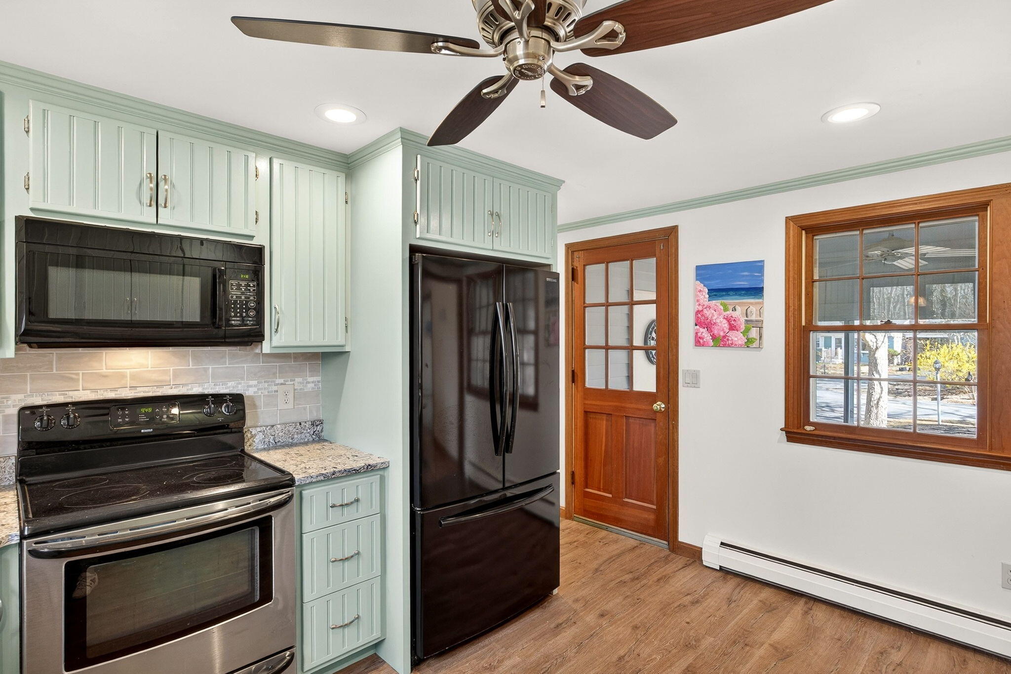 12 Inkberry Lane Harwich, MA 02645 - Photo 5 of 41 a kitchen with stainless steel appliances granite countertop a refrigerator and a stove top oven