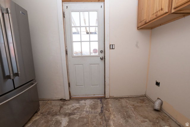 570 West Main Street Beaver, UT 84713 - Photo 11 of 43 Utility space featuring a partial stainless steel refrigerator, light-toned upper cabinetry, and a door with divided lites