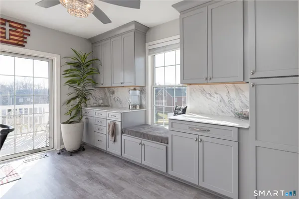 a kitchen with kitchen island granite countertop a refrigerator and a sink