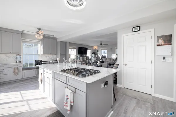a view of a house with pool and sitting area