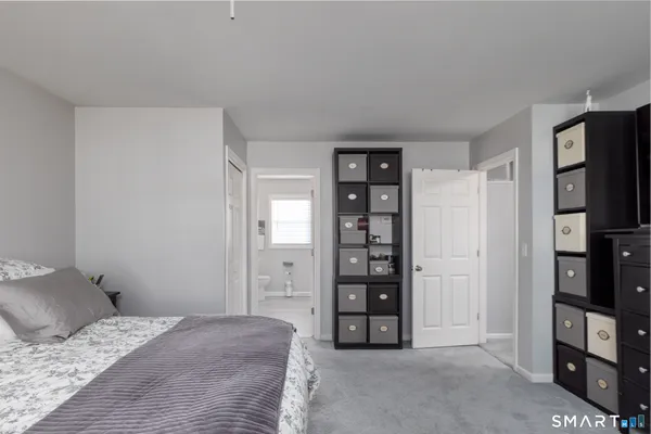 a bathroom with a granite countertop sink mirror and a toilet