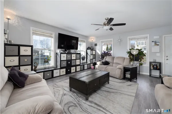 a living room with furniture flat screen tv and a fireplace