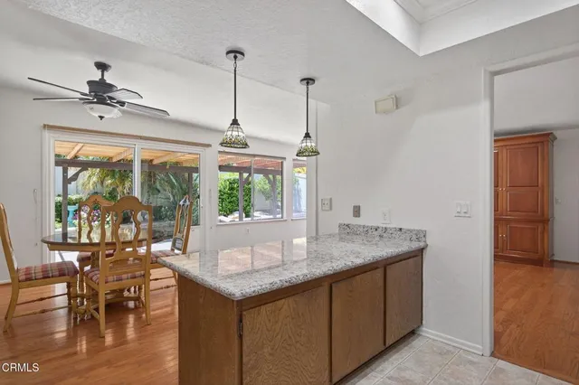 a kitchen with a table a sink and cabinets
