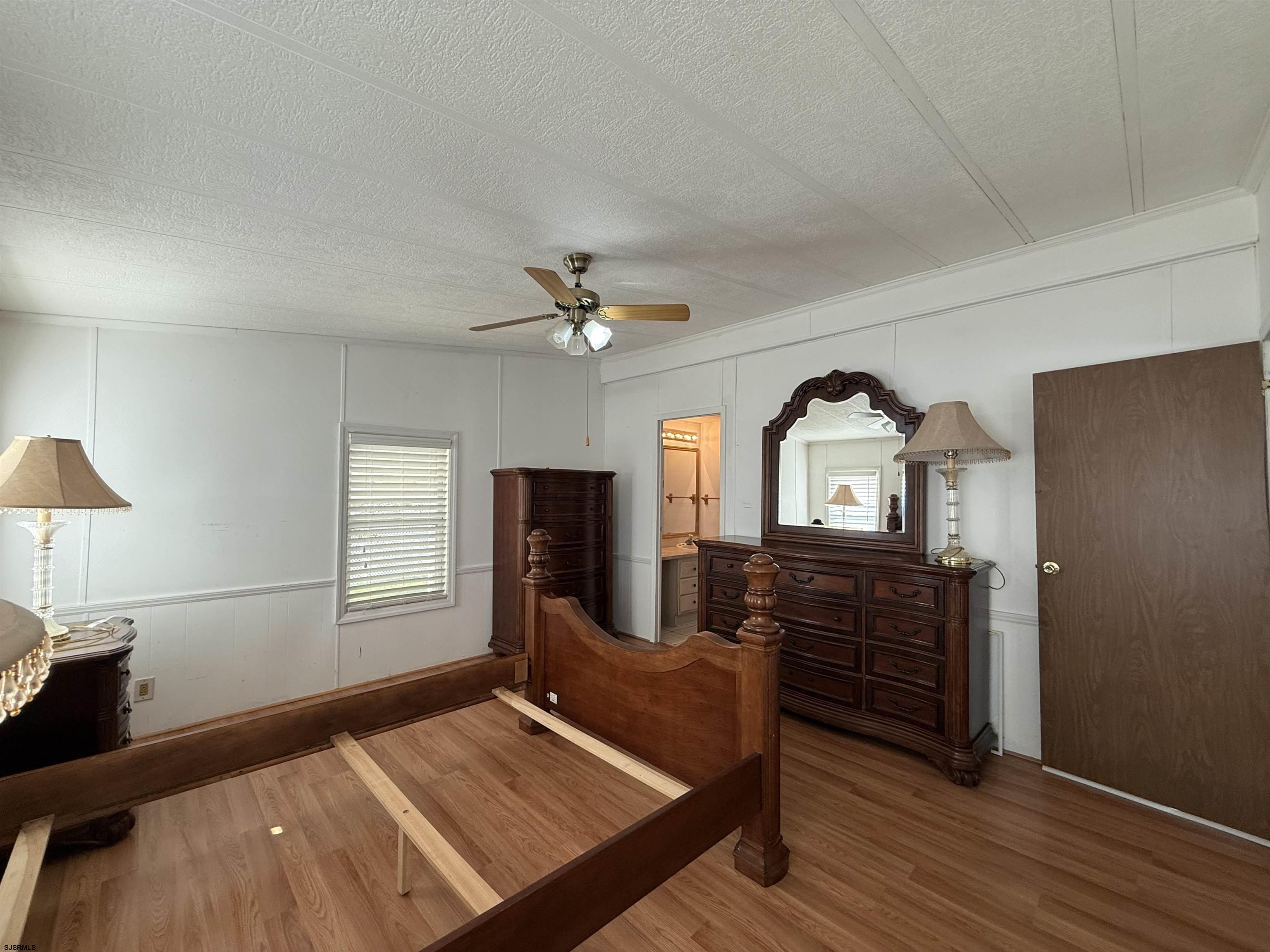 386 Indian Way Buena, NJ 08310 - Photo 14 of 37 a bedroom with a bed and wooden floor