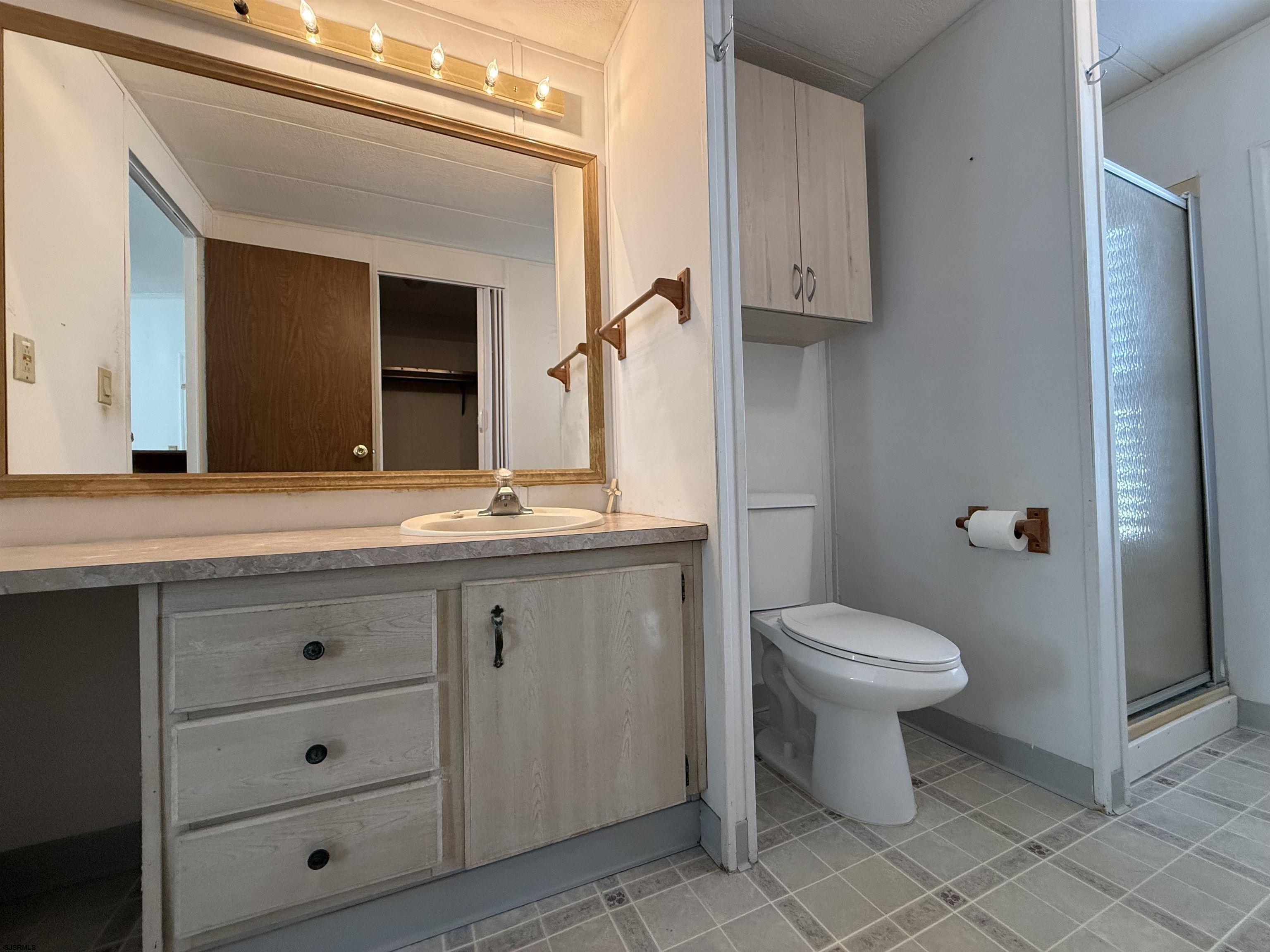 386 Indian Way Buena, NJ 08310 - Photo 21 of 37 a bathroom with a toilet sink and mirror