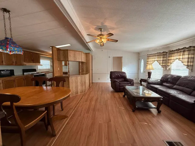 a living room with furniture a wooden floor and a window