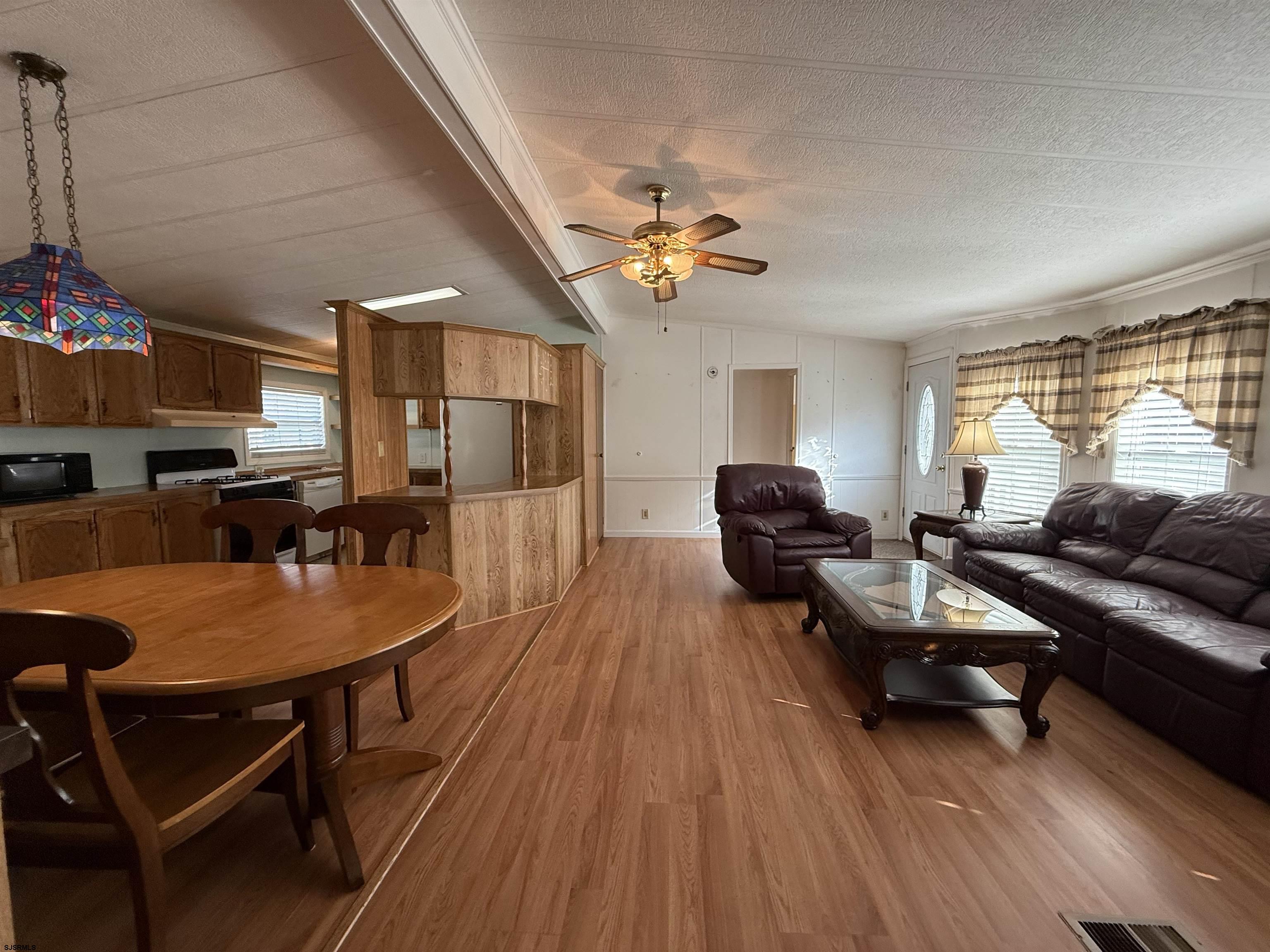 386 Indian Way Buena, NJ 08310 - Photo 22 of 37 a living room with furniture a wooden floor and a window
