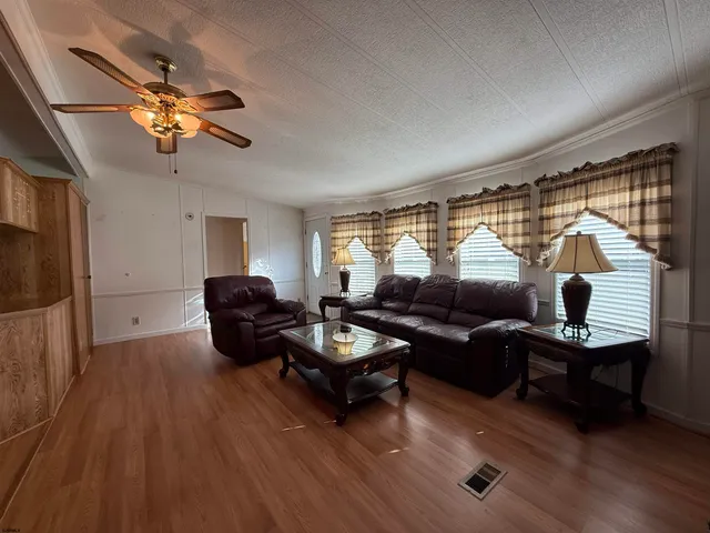 a living room with furniture a window and a flat screen tv