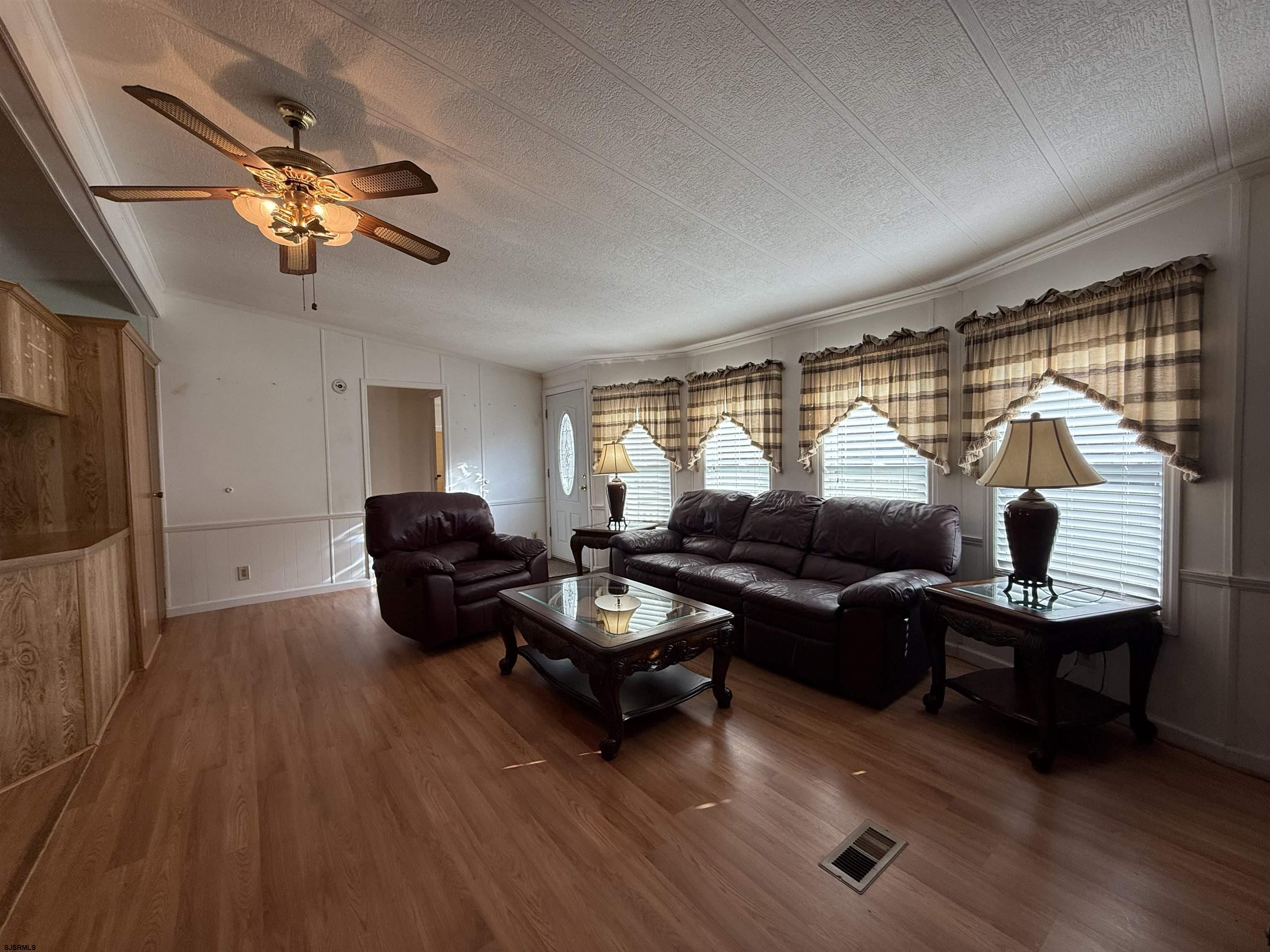 386 Indian Way Buena, NJ 08310 - Photo 23 of 37 a living room with furniture a window and a flat screen tv