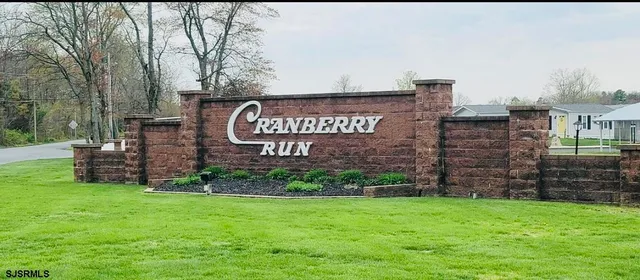 a view of sign board with tall buildings