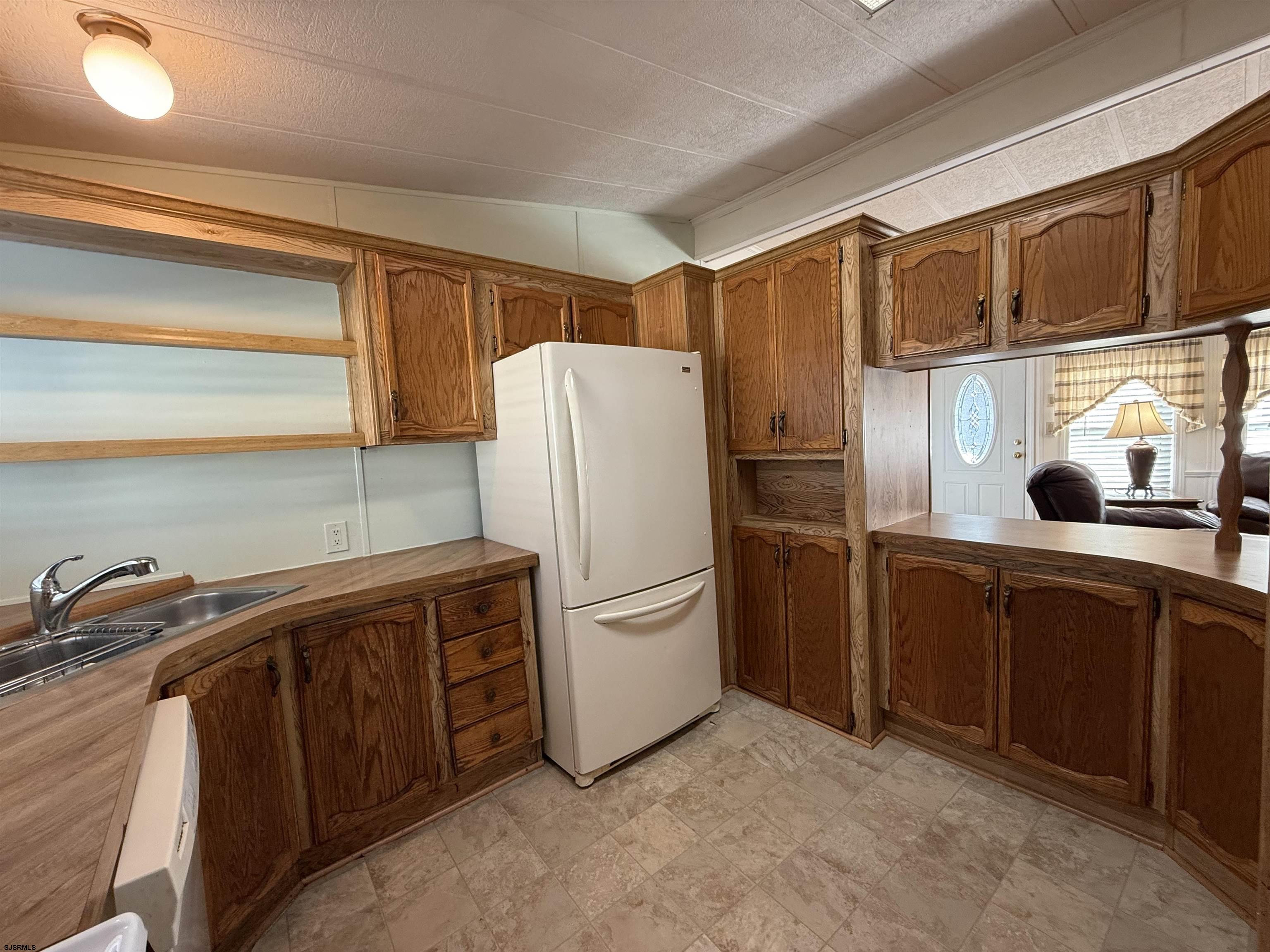386 Indian Way Buena, NJ 08310 - Photo 7 of 37 a kitchen with stainless steel appliances a refrigerator and a sink