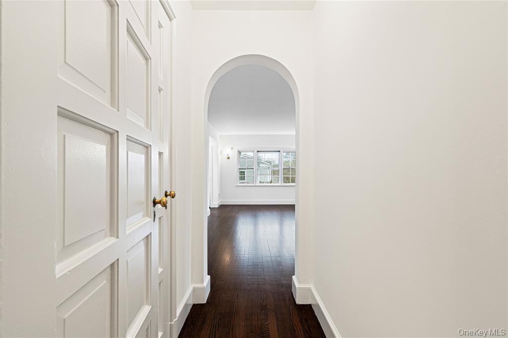 6 Fox Meadow Road Scarsdale, NY 10583 - Photo 10 of 20 Corridor with arched walkways, dark wood-style flooring, and baseboards
