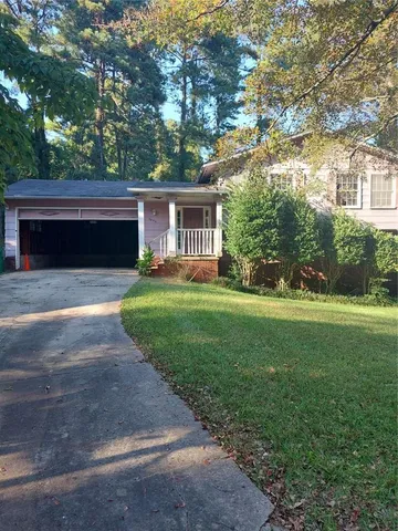 a front view of house with yard and green space