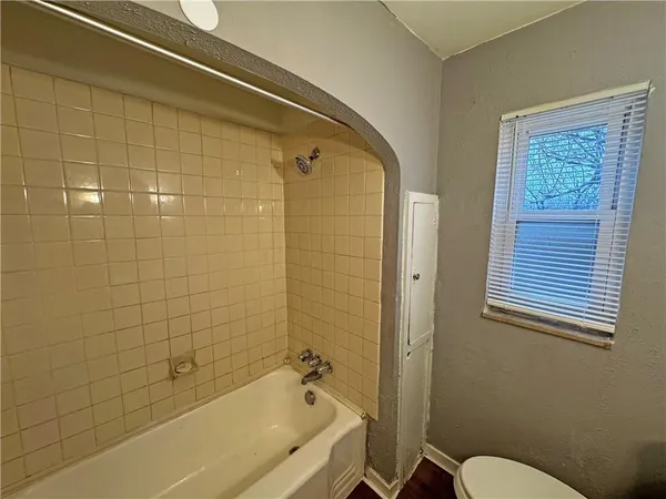 a bathroom with a bathtub and shower
