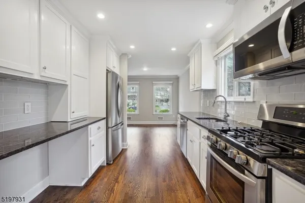 a kitchen with stainless steel appliances granite countertop a stove and a sink
