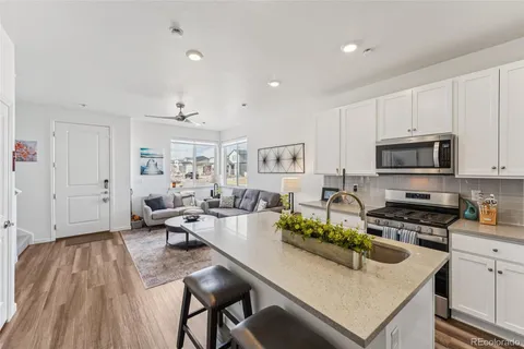 a kitchen with sink a stove and cabinets