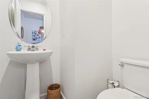 a bathroom with a sink mirror and toilet