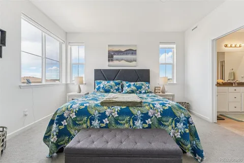 a bed sitting in a bedroom next to a window