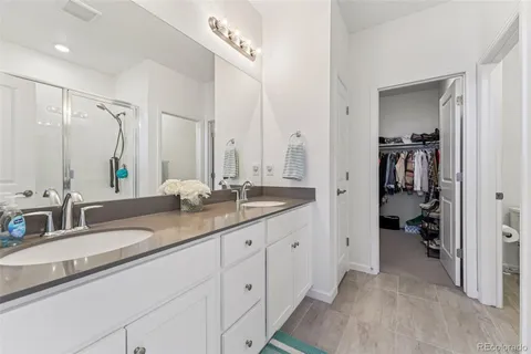 a bathroom with double sink and a mirror