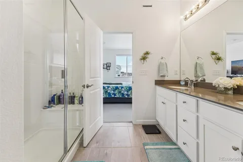 a spacious bathroom with a double vanity sink and mirror