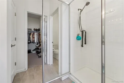 a bathroom with a shower and a mirror