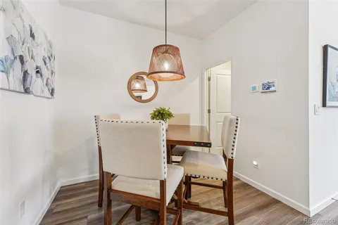 a dining room with a table and chairs