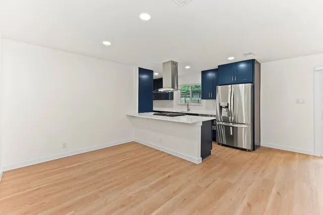 a kitchen with stainless steel appliances a refrigerator and a stove