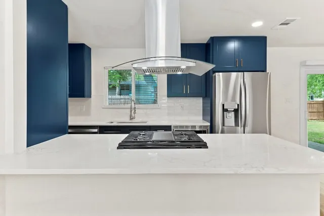 a kitchen with stainless steel appliances granite countertop a stove and a refrigerator