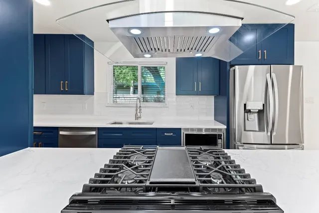 a kitchen with a stove and a refrigerator