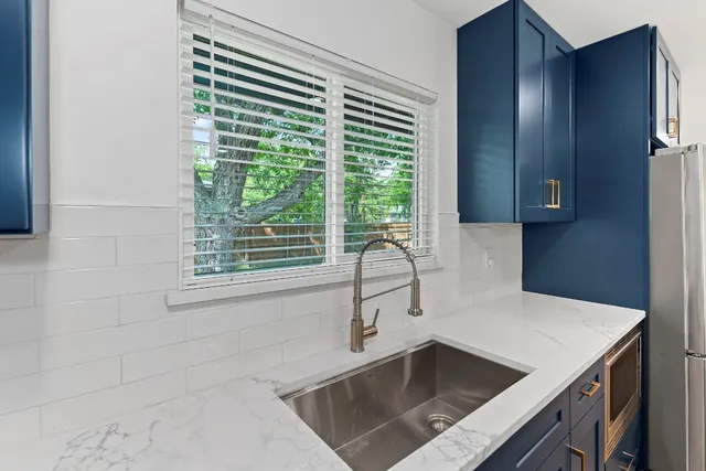 a kitchen with a sink and large window