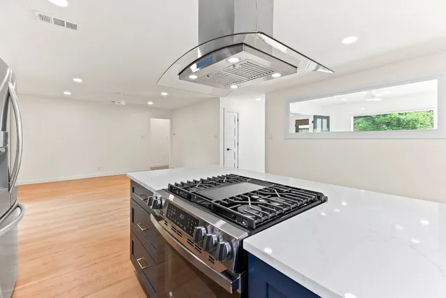 a stove top oven sitting inside of a kitchen