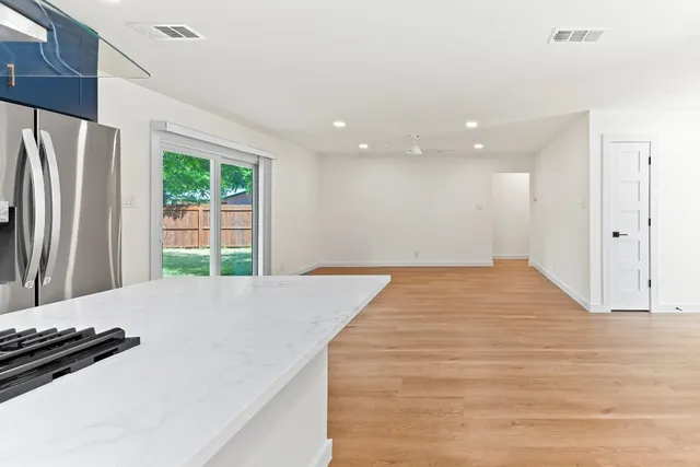 a room with a bed and a dresser