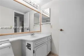 a bathroom with a sink vanity and a mirror