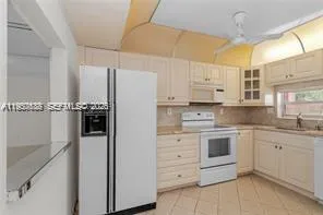 a kitchen with stainless steel appliances granite countertop white cabinets sink and dishwasher