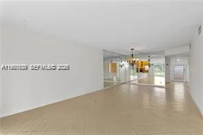 a view of empty room with floor to ceiling window and fireplace