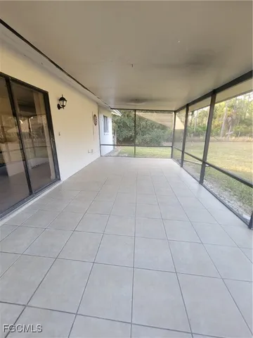 a view of an empty room with a floor to ceiling window and a living room