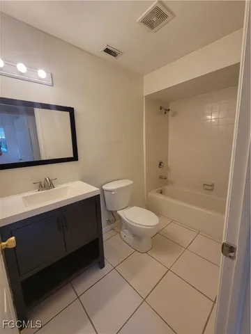 a bathroom with a toilet sink shower and mirror