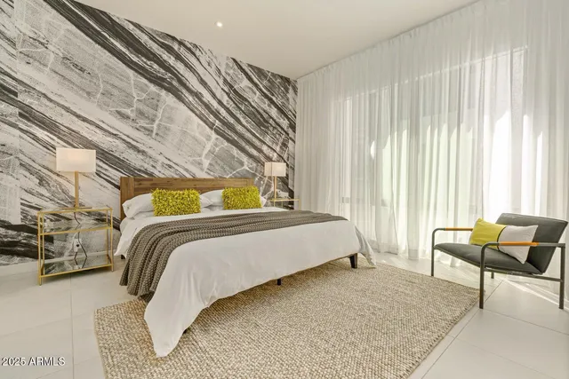 a bedroom with a bed and chair