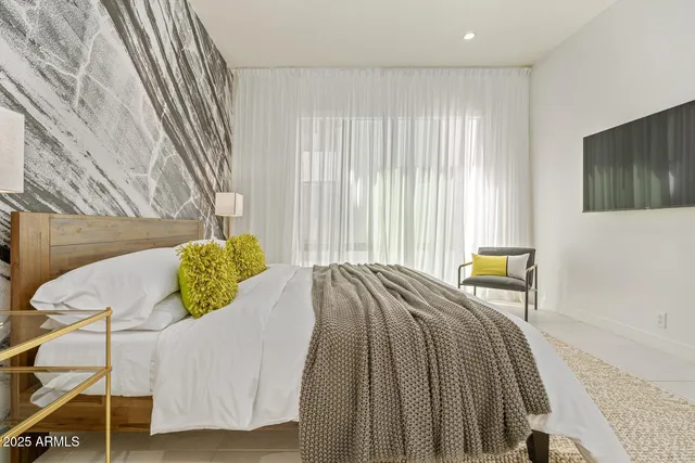 a bedroom with a bed and a window