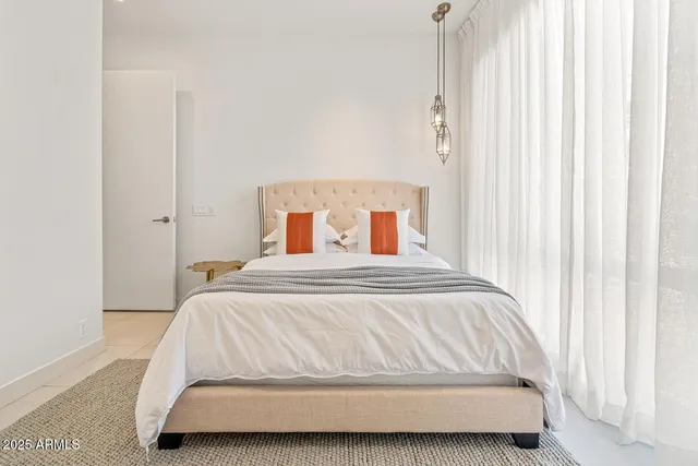 a bedroom with a bed and curtain