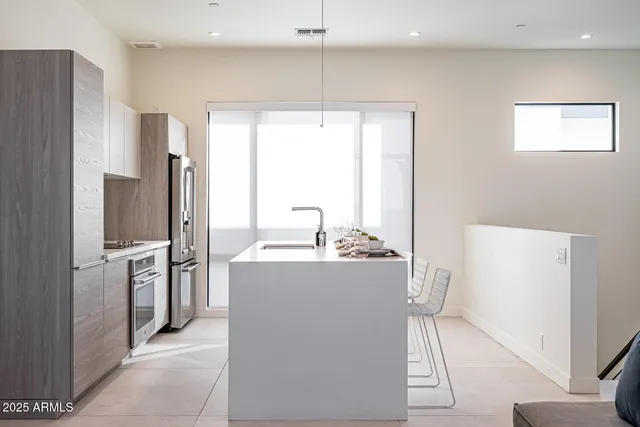 a kitchen with stainless steel appliances a refrigerator and a stove