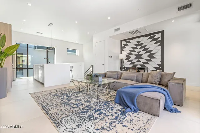 a living room with furniture and a rug