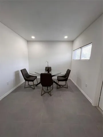 a view of a big room with lounge chair and windows