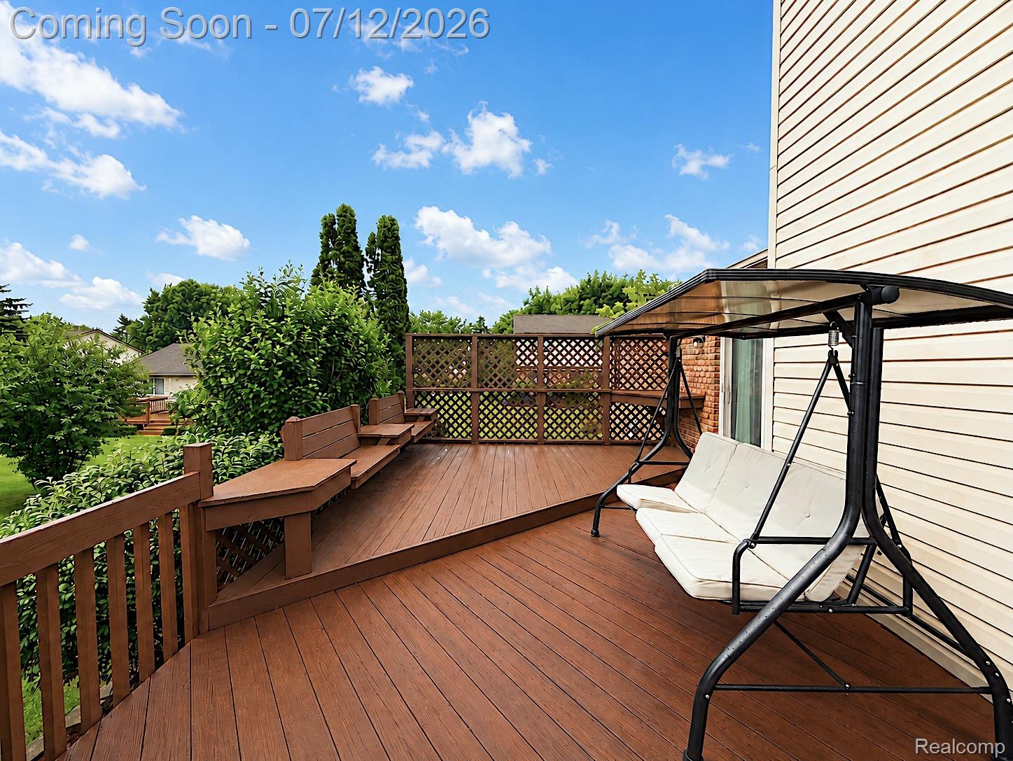 2033 Avonstoke Road Rochester, MI 48307 - Photo 25 of 26 Expansive wood-finish deck featuring integrated bench seating and lattice privacy screens