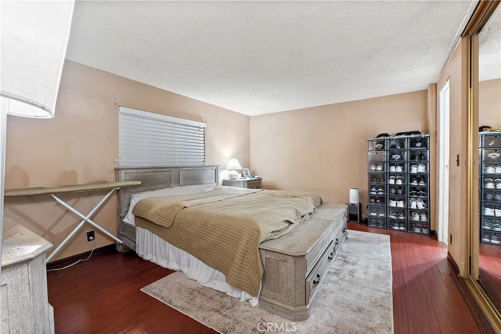 1051 Site, Unit 251 Brea, CA 92821 - Photo 12 of 23 a bedroom with a bed and a wooden floor