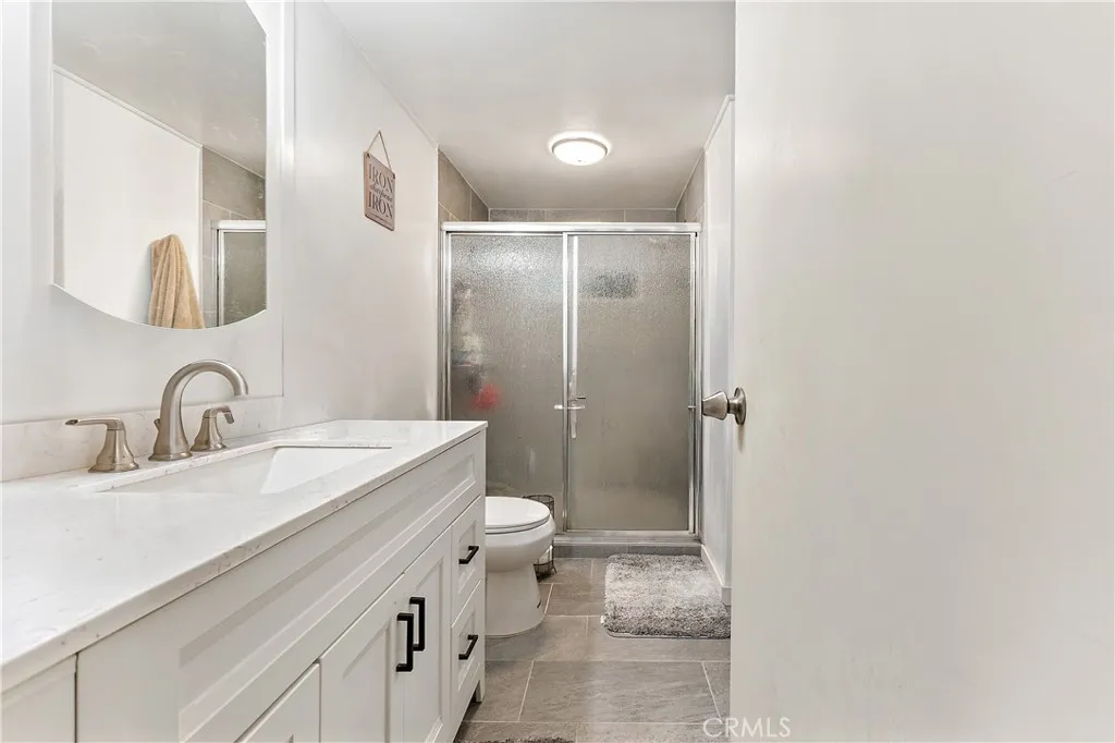 1051 Site, Unit 251 Brea, CA 92821 - Photo 14 of 23 a bathroom with a sink and mirror with toilet